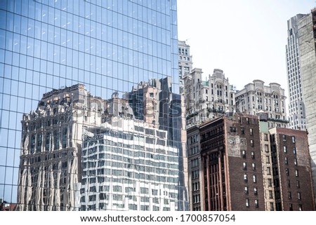 reflections of various buildings in new york