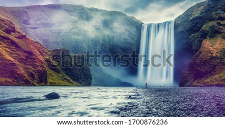 Impressive scenery of the majestic Skogafoss Waterfall of Iceland during sunrise. Amazing landscape with dramatic picturesque sky. Iceland the most beautiful and best travel place. Beauty of World Royalty-Free Stock Photo #1700876236