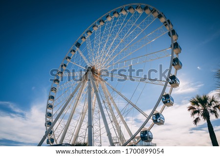 big ferris wheel in front of blue sky