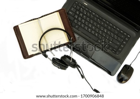 Modern workplace, accessories laptop, headphones, mouse, Notepad on a white background . the view from the top
