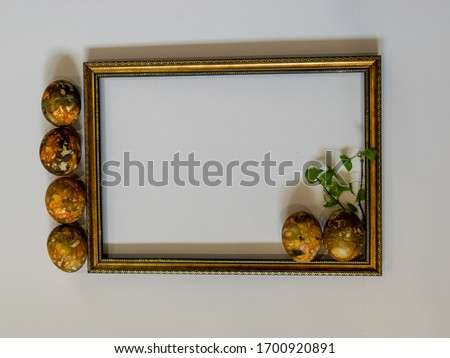picture with wooden frame and colorful Easter eggs, suitable for greeting text