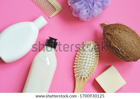 Flat lay beauty photography white shampoo bottle, hair balm, wooden comb, natural soap with coconut oil. Organic cosmetic products for hair and skin care
