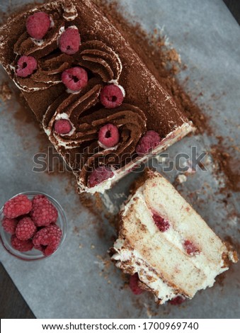 Delicious white cake with air cream, chocolate sprinkles, decoration of red berries. Home baking, cooking recipe, cake for a celebration