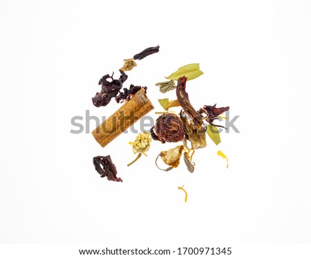 dried herbal tea leaves on white background; cinnamon, daisy, rosehip