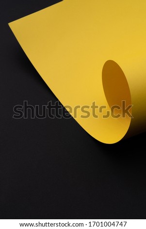 Roll yellow paper. Paper texture background. Color. Copy space. Dark mode style. Top view. Minimal concept. Vertical photo