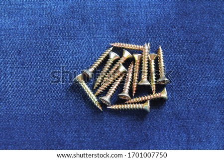 Self-tapping screws on a denim background