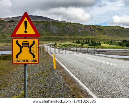 The famous Einbreid Bru sign in Iceland next to a bridge