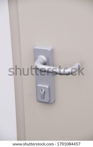 Emergency exit door, lock system and door handle detail