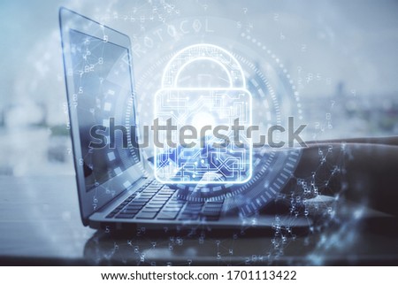 Double exposure of woman hands working on computer and lock hologram drawing. Security concept.
