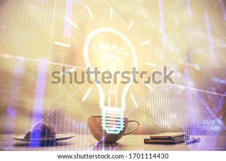 Double exposure of light bulb hologram over coffee cup background in office. Concept of idea