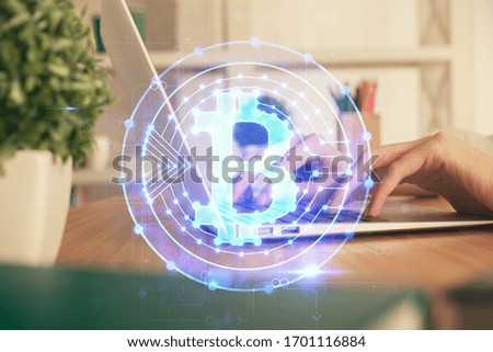 Double exposure of woman hands typing on computer and crypto market theme hologram drawing. Blockchain concept.