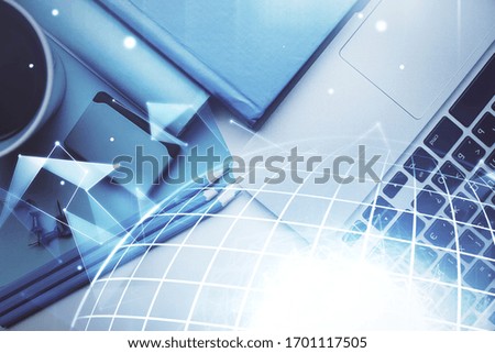 Double exposure of map hologram drawing over study table background with computer. Concept of international network. Top view.