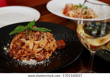 Tagliatelle Pasta with Bolognese Sauce served with White Wine