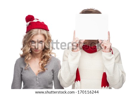 young funny casual caucasian couple holding sign and looking angry at camera