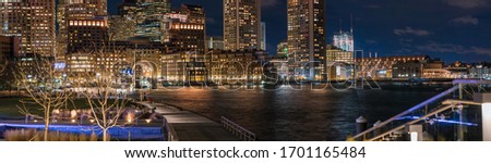 Panoramic view of Boston Harbor and Financial District skyline at sunset in Boston, Massachusetts USA