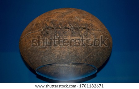 Old football used in the 1890s which has similar shape to a rugby ball. American football evolved from a combination of soccer and rugby.