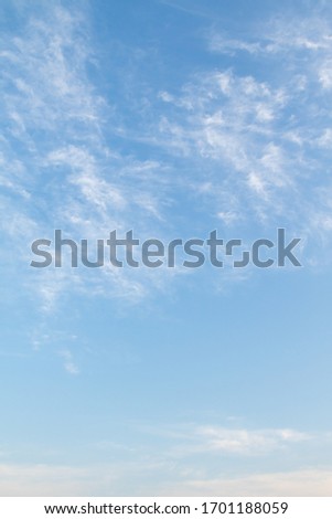 Cirrus clouds against a blue sky on a clear Sunny day.