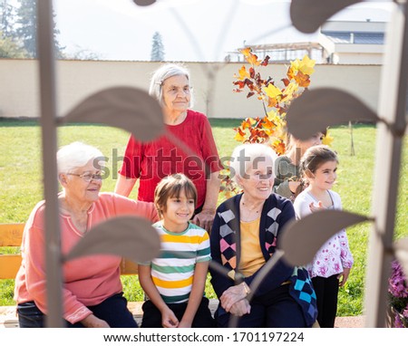 Old people sitting with kids