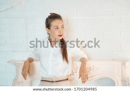 Portrait of beautiful woman standing against white
