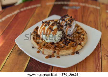 waffle with two scoops of ice cream and chocolate chips