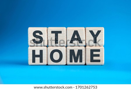 Stay home - text on wooden cubes and blue background