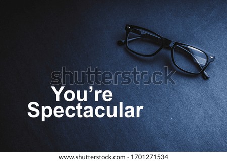YOU ARE SPECTACULAR with Eye Glasses or spectacle on black background. Selective focus