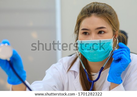 Portrait Of Female Doctor Examining With Stethoscope ,selective focus on  Doctor .