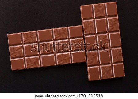 Chocolate on a dark background. Two chocolate bars