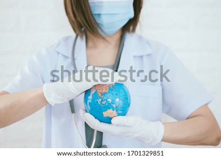 The world in the hands of a doctor protect the world from viruses.