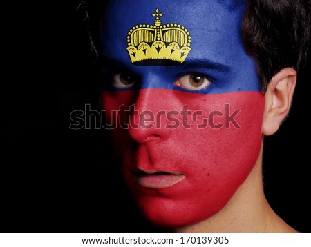 Flag of Liechtenstein Painted on a Face of a Young Man
