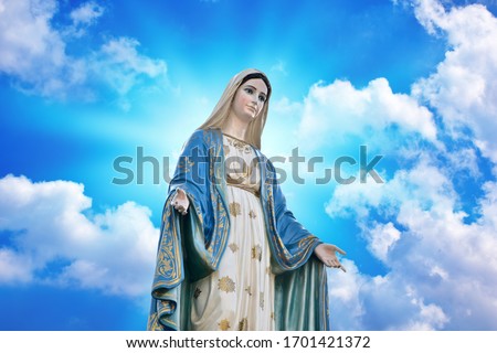 Our lady of grace virgin Mary with Bright Blue Sky and beautiful clouds with abstract colored background and wallpaper. Royalty-Free Stock Photo #1701421372