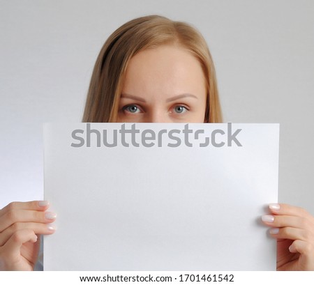 young woman with empty paper sheet. Poster with copy-space concept