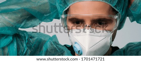 Doctor wearing protection face mask and glasses against coronavirus. Banner panorama medical staff preventive gear.