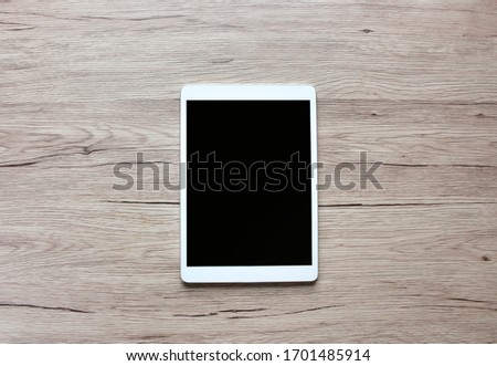 Tablet  Put on a wooden table with copy space.