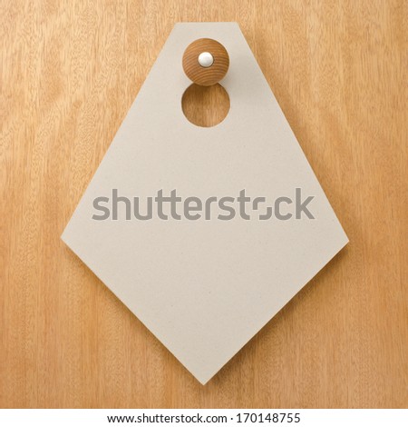 Paper signboard hanging on a handle of door  