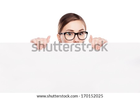 business woman looking over top of white sign 