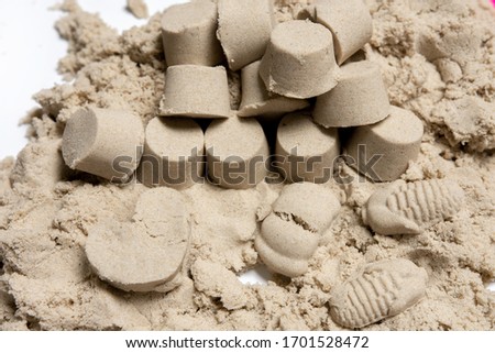 many small towers of kinetic sand. play with a child.