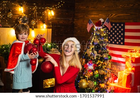 Christmas in America. Brother and sister celebrate Christmas or New Year on american flag background. Happy family in USA - Brother and sister celebrate Christmas or New Year