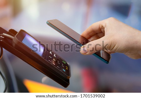 making mobile payments from pos device via mobile phone Royalty-Free Stock Photo #1701539002