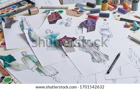 Fashion designer stylish drawings sketches textile fabric material Costume. Designer creative workshop studio.                         