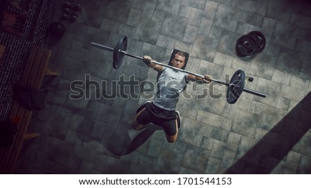 Top View of Professional Athlete Doing Bench Press Workout with a Barbell in the Hardcore Gym. Muscular and Athletic Bodybuilder Doing Barbell Exercise. Royalty-Free Stock Photo #1701544153