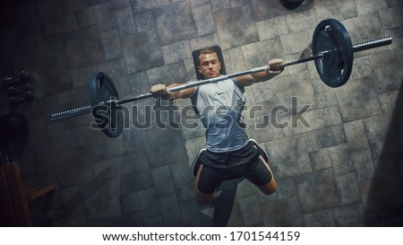 Top View of Professional Athlete Doing Bench Press Workout with a Barbell in the Hardcore Gym. Muscular and Athletic Bodybuilder Doing Barbell Exercise. Royalty-Free Stock Photo #1701544159