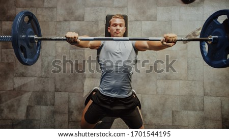 Top View Shot of Professional Athlete Doing Bench Press Workout with a Barbell in the Hardcore Gym. Muscular and Athletic Bodybuilder Doing Barbell Exercise. Royalty-Free Stock Photo #1701544195