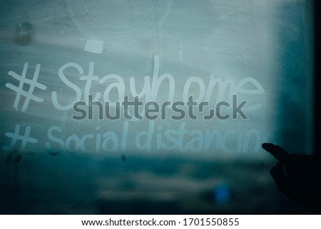 Stayhome and social distancing hand writing on the mirror  Royalty-Free Stock Photo #1701550855