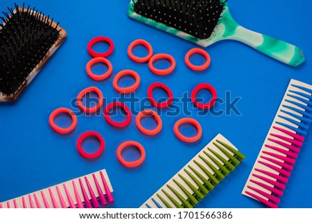 on a blue background are combs hair clips elastic bands, hairdressing accessories