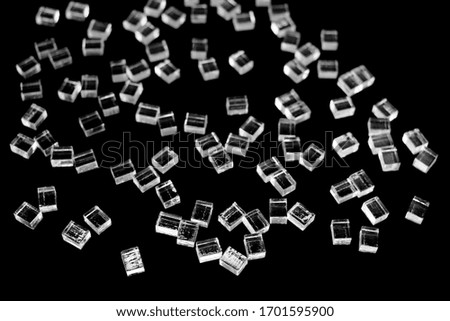 abstract plastic parallelepipedic shapes on a dark background