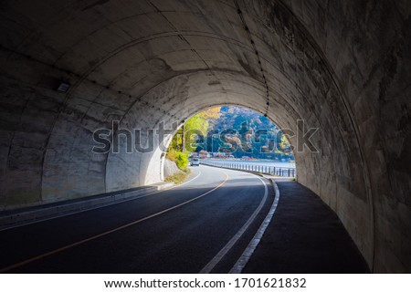 Japan. The tunnel leads to Lake Kawaguchiko. Departure from a tunnel on a highway in Japan. The end of the car tunnel in Fyuzhikavaguchiko. Road architecture of Japan. Trip to Kawaguchiko Lake Royalty-Free Stock Photo #1701621832
