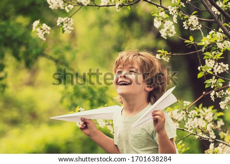 Spring game. Boy in the garden. Toy plane mood. Dream for children. Blossom trees walk.