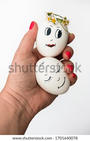 Bright holiday Easter. Beautiful painted egg in a hand against a white background