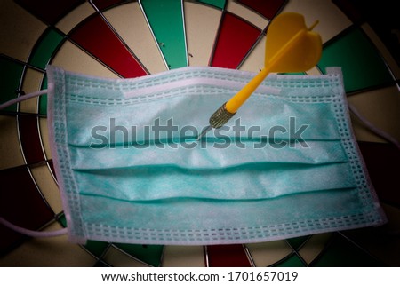 Yellow dart embroidered on health mask, Concept of WE WILL WIN on coronavirus,covid-19 outbreak around the world. Royalty-Free Stock Photo #1701657019